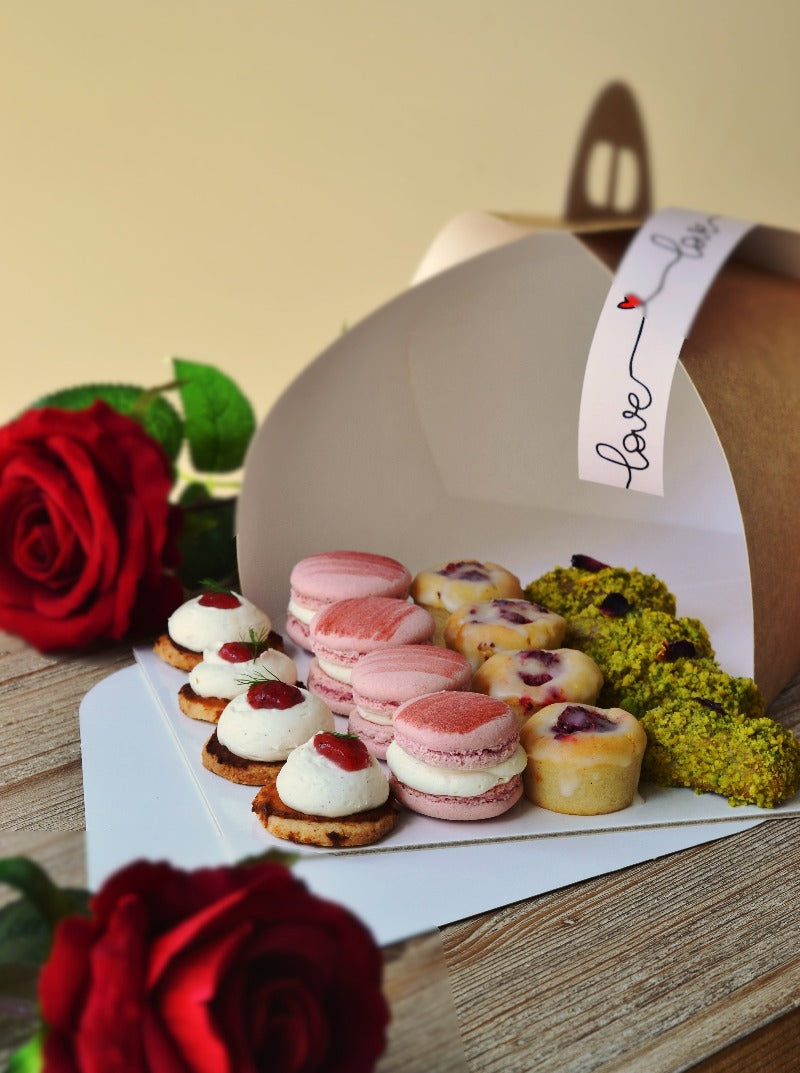 Regalo de rosas comestibles para sant jordi y cake de dragón (pistacho) en una bandeja surtida de pastelería vegana y sin gluten para compartir.